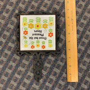vintage cast iron and ceramic tile trivet